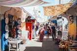 A bustling local market in Seville showcasing diverse products and services.