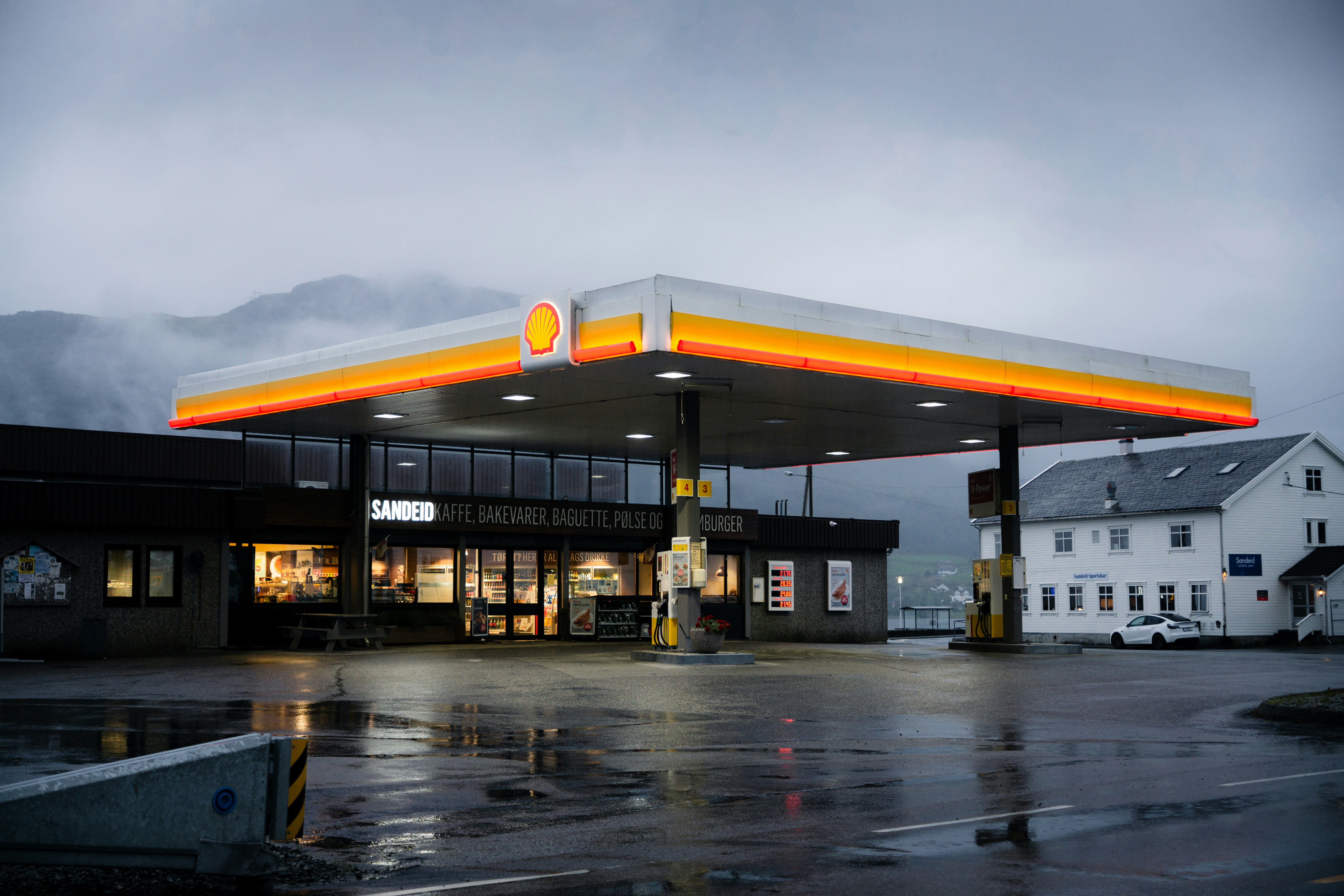 a gas station on a rainy day with a cloudy sky