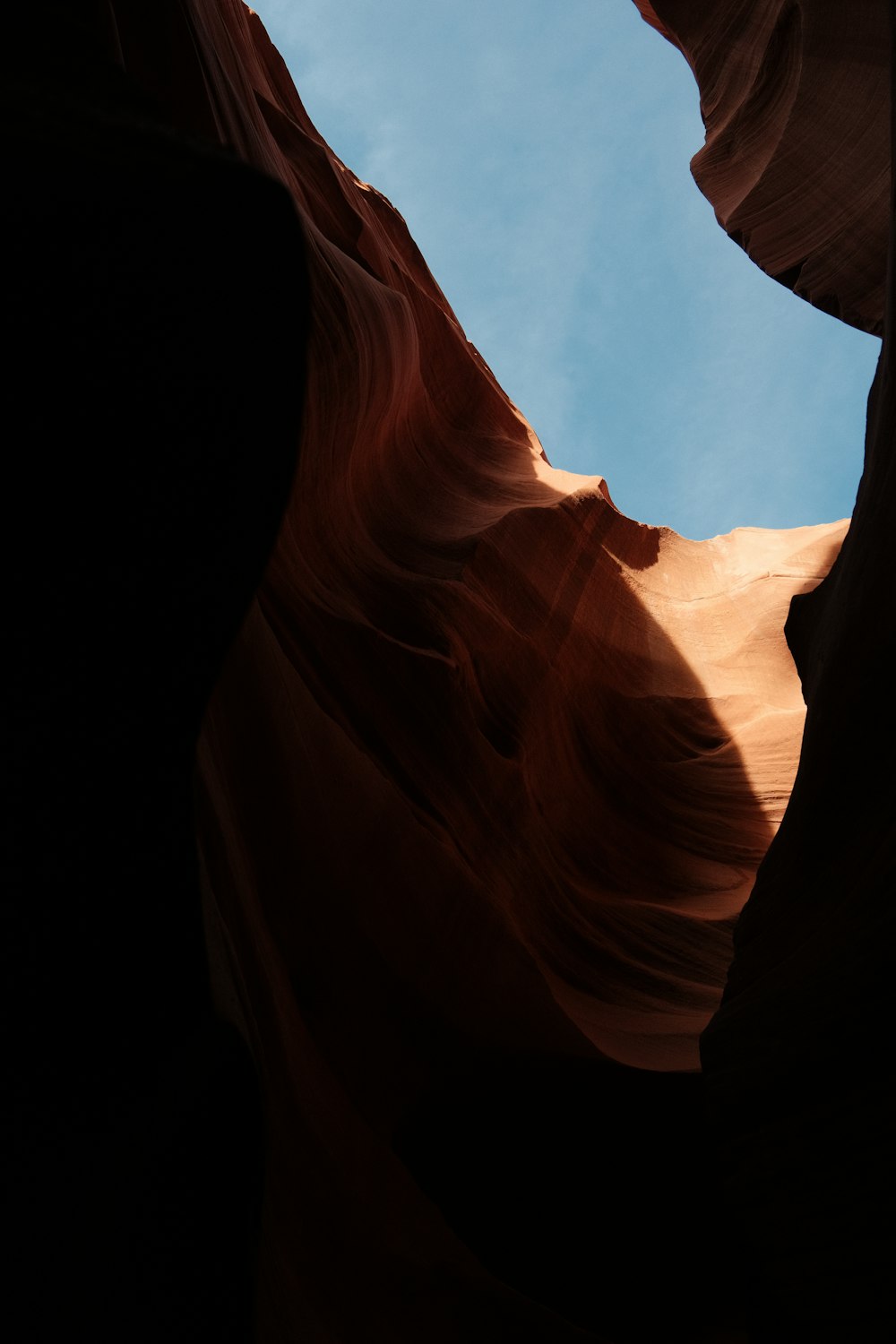 a view of the sky from inside a canyon