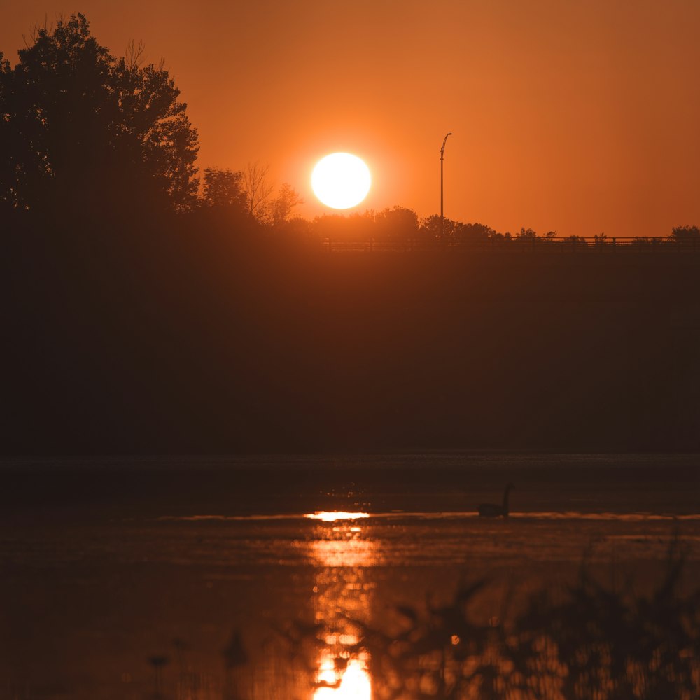 the sun is setting over a body of water