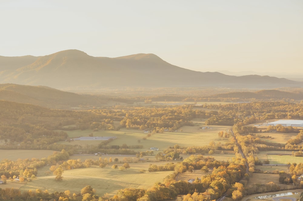 a scenic view of a valley with mountains in the background