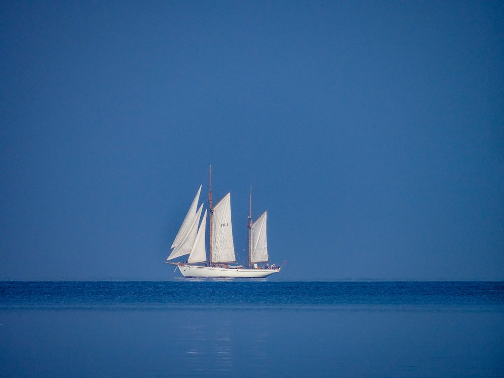 a sailboat sailing across a large body of water