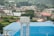 A close-up of a water storage tank in a residential setting, surrounded by greenery.