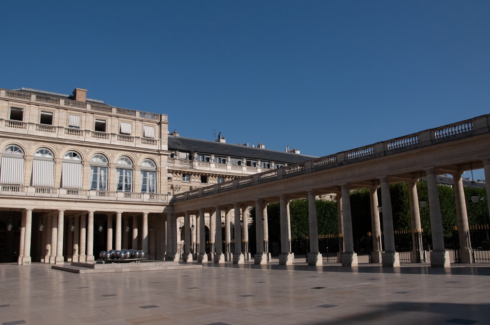 a large building with columns and a car parked in front of it