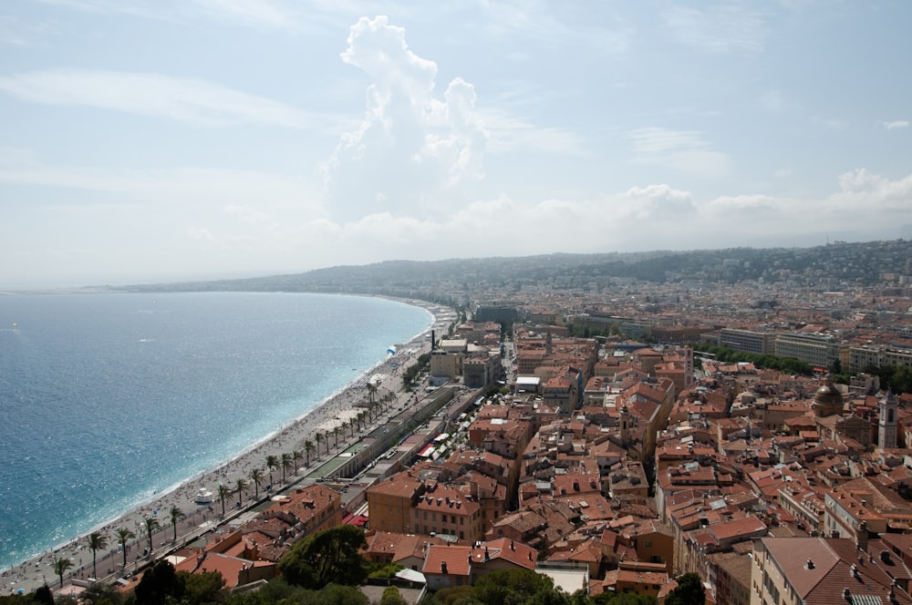 an aerial view of a city next to the ocean