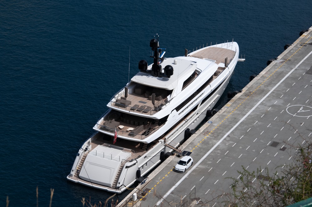 a large white boat is docked at a dock