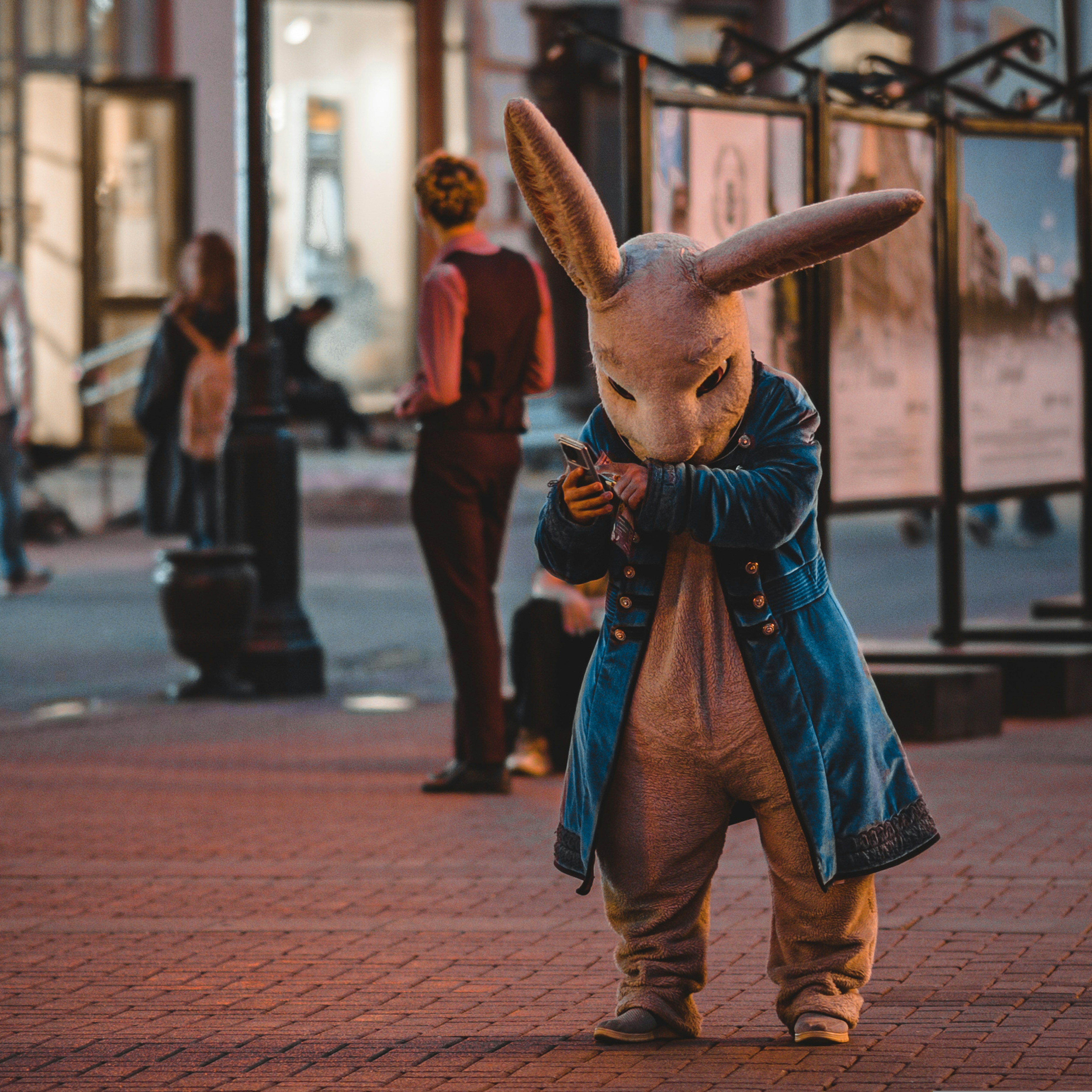 a person in a bunny suit walking down a street