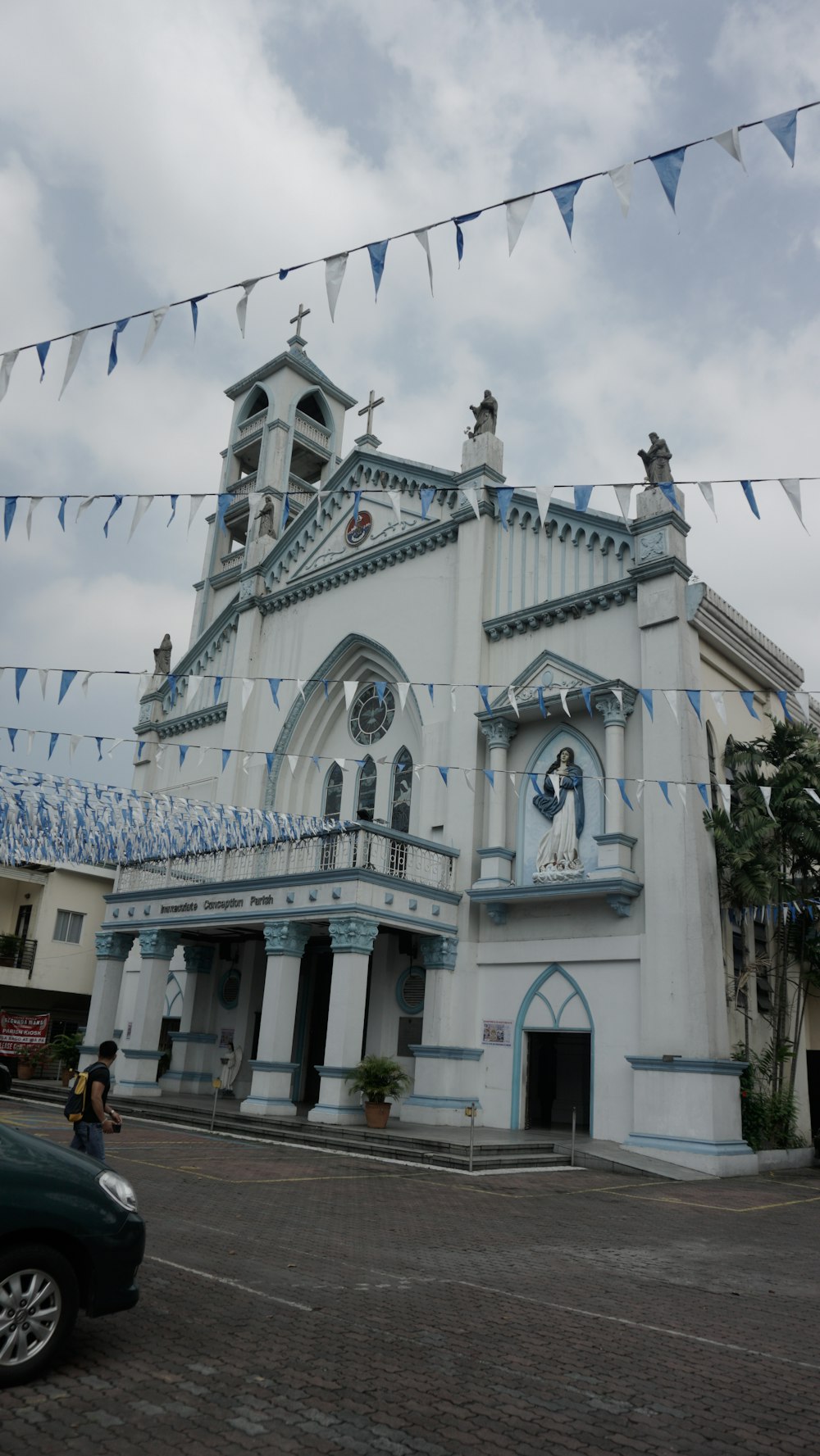 a large white building with a blue and white roof