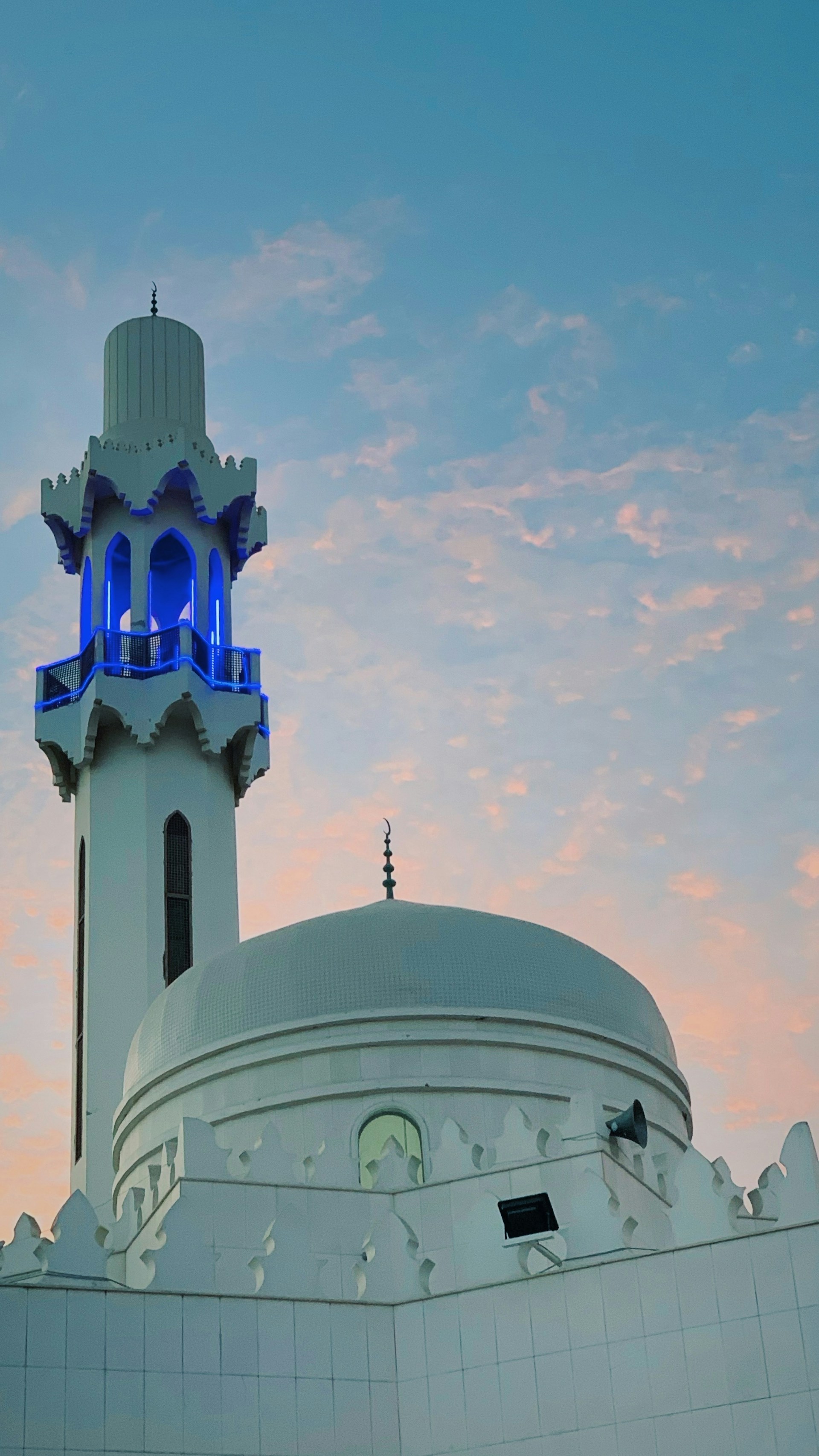 A serene view of the mosque during sunset, highlighting its architectural beauty and peaceful surroundings.