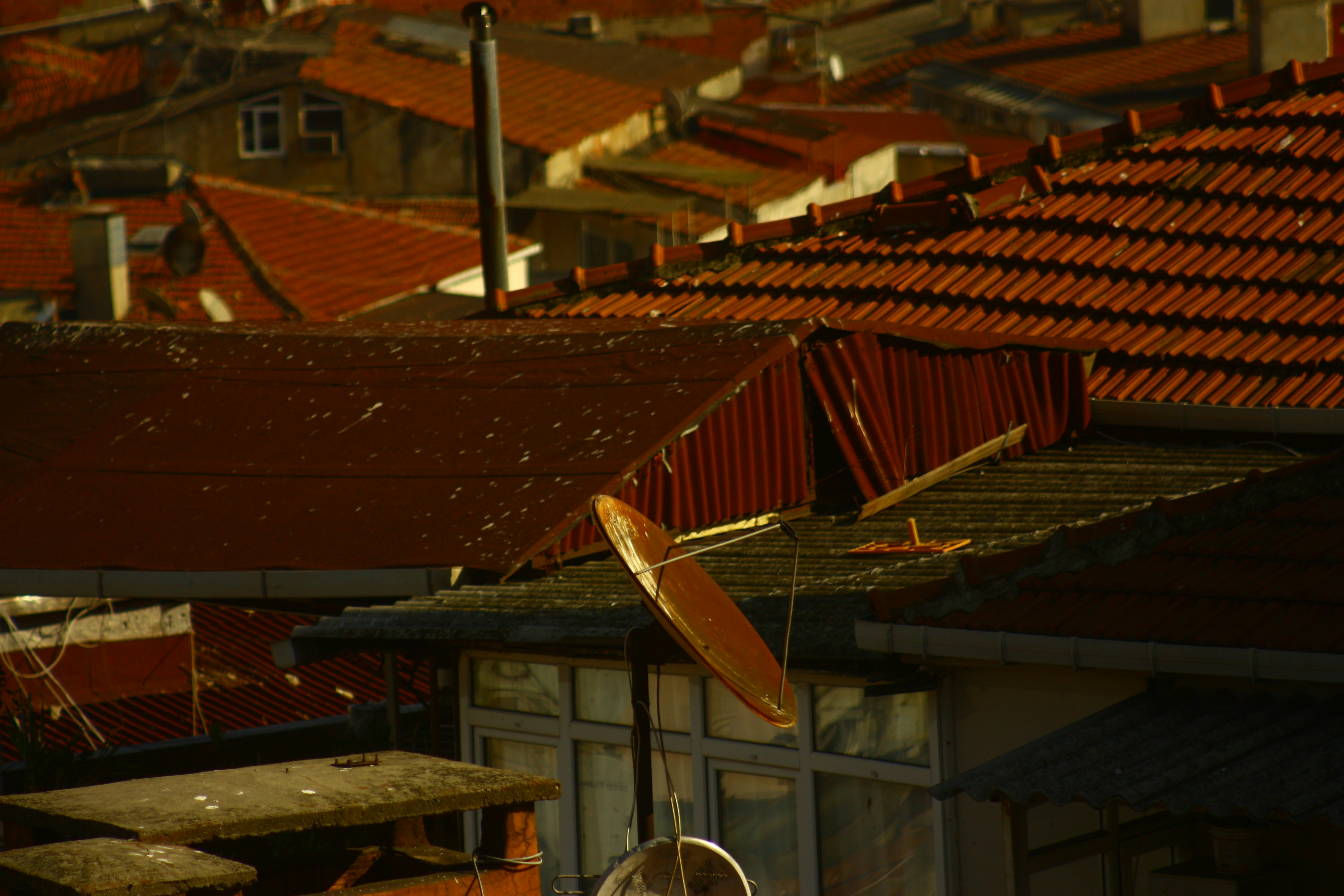 a satellite dish on top of a roof of a building
