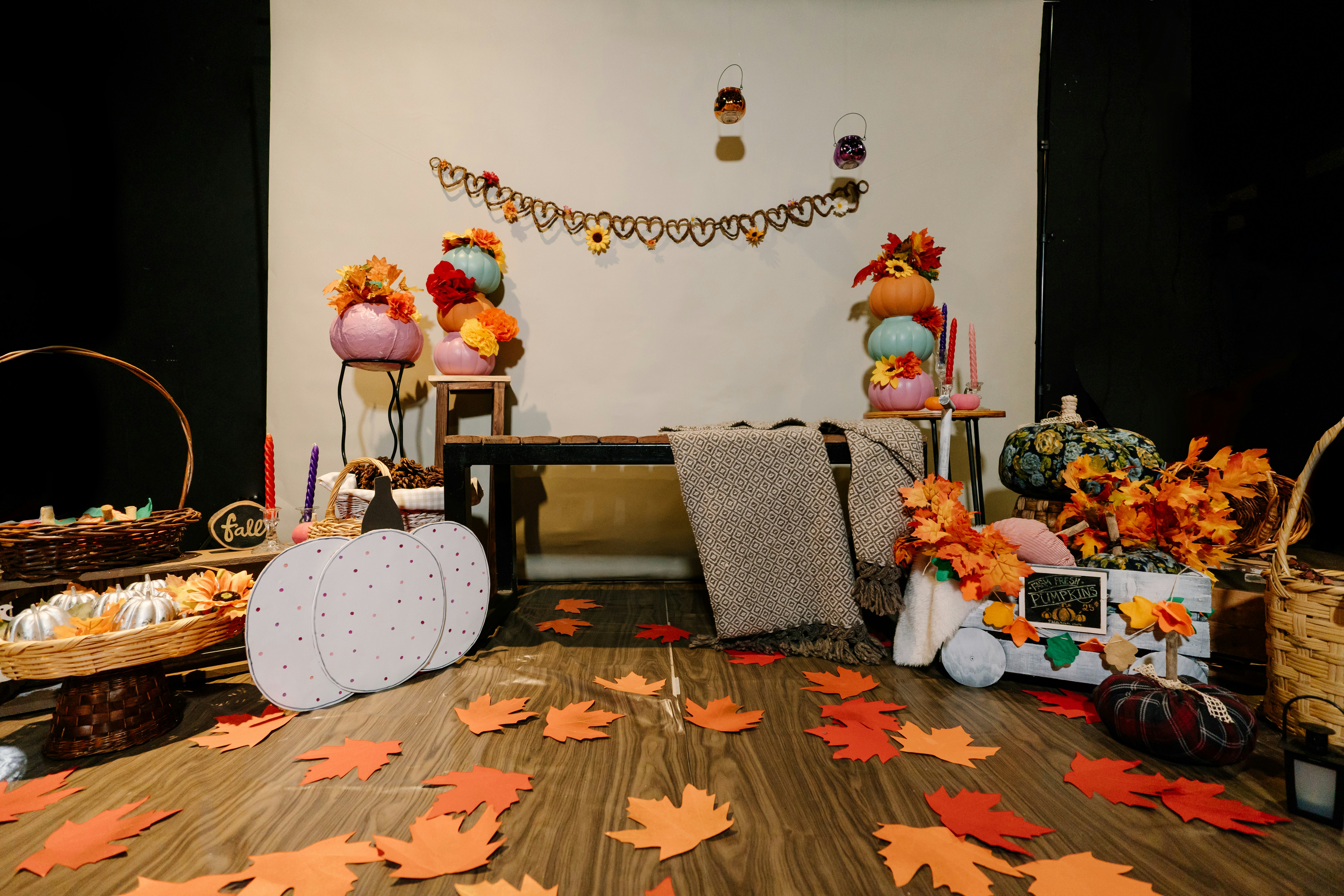 A warm, cozy RV interior with autumn-themed decorations, showcasing blankets and layered clothes