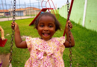 A joyful child playing in a colorful playground.