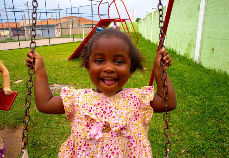 A joyful child playing in a colorful playground.
