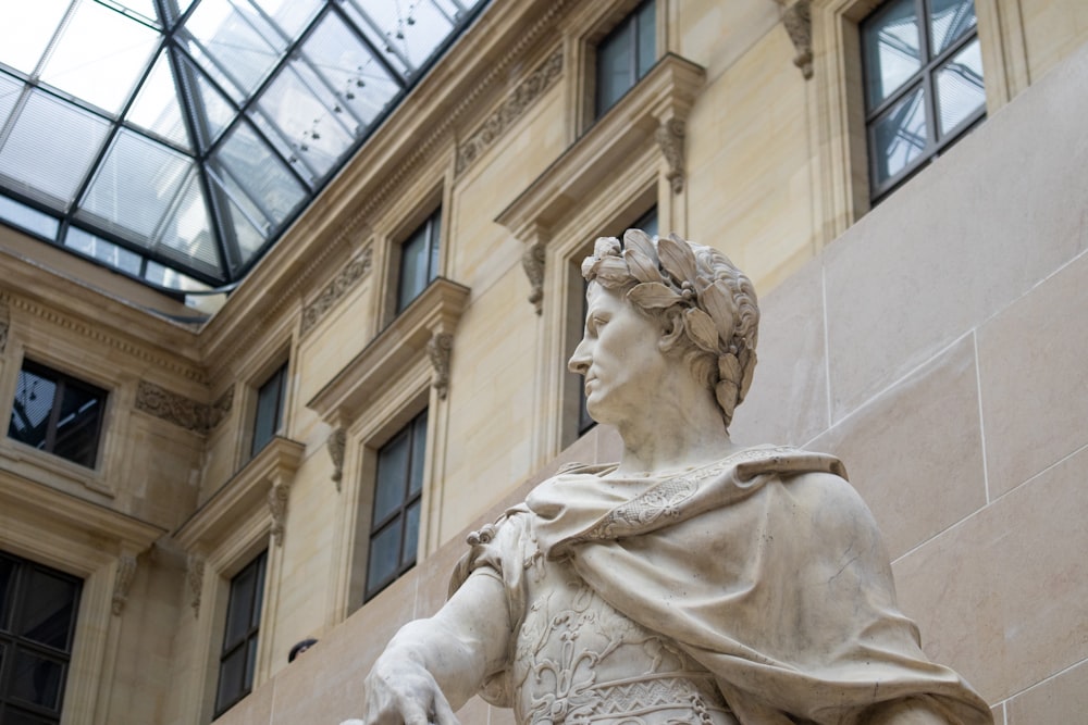 a statue of a roman emperor in front of a building