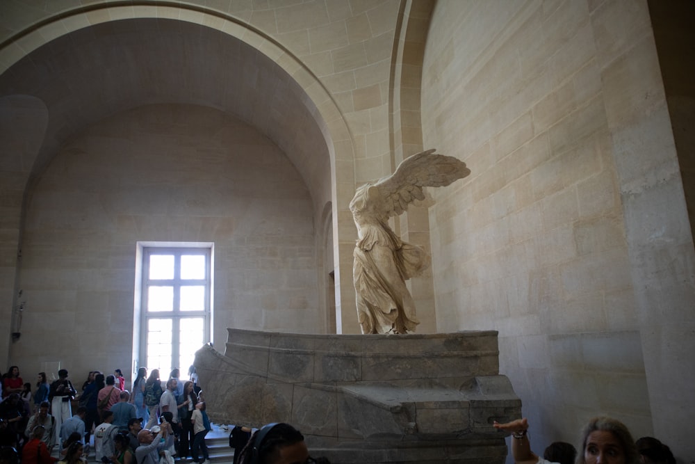 a group of people standing around a statue