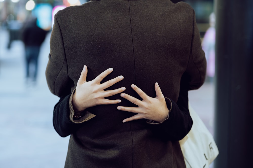 a woman holding her hands on her back