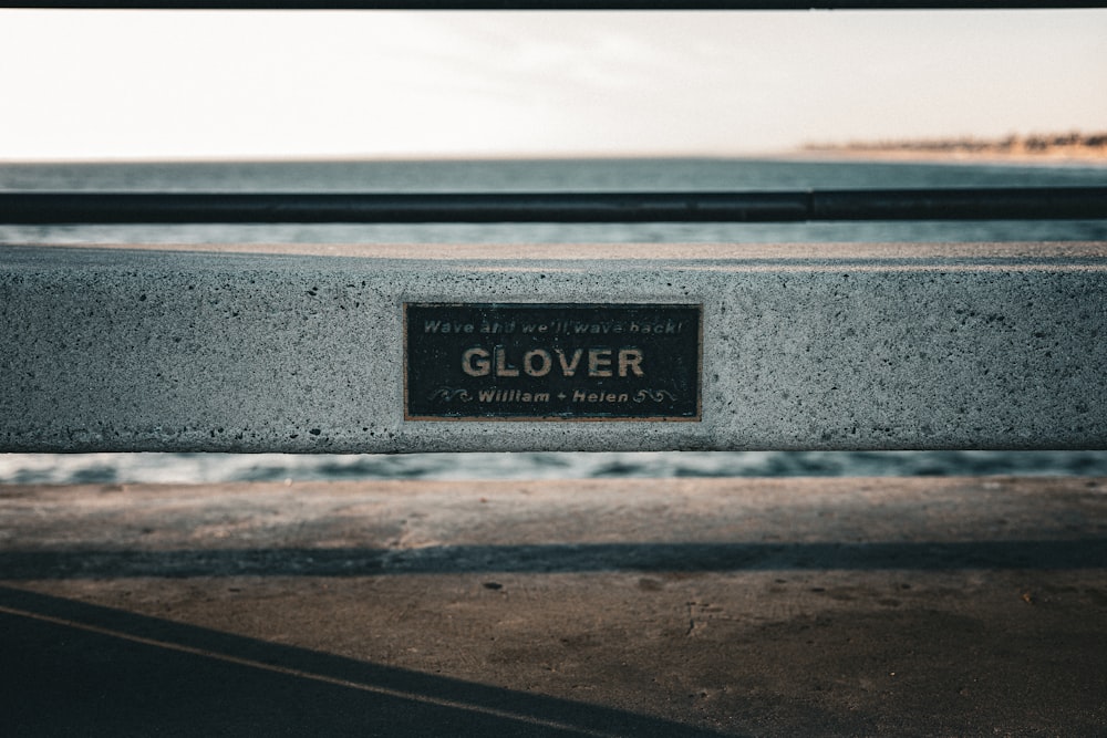 a close up of a bench with a sign on it