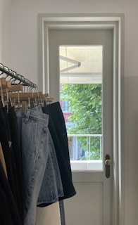 A customer trying on jeans in a fitting room.