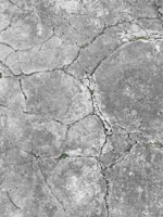 Repaired concrete driveway with visible patchwork blending seamlessly into the original surface.