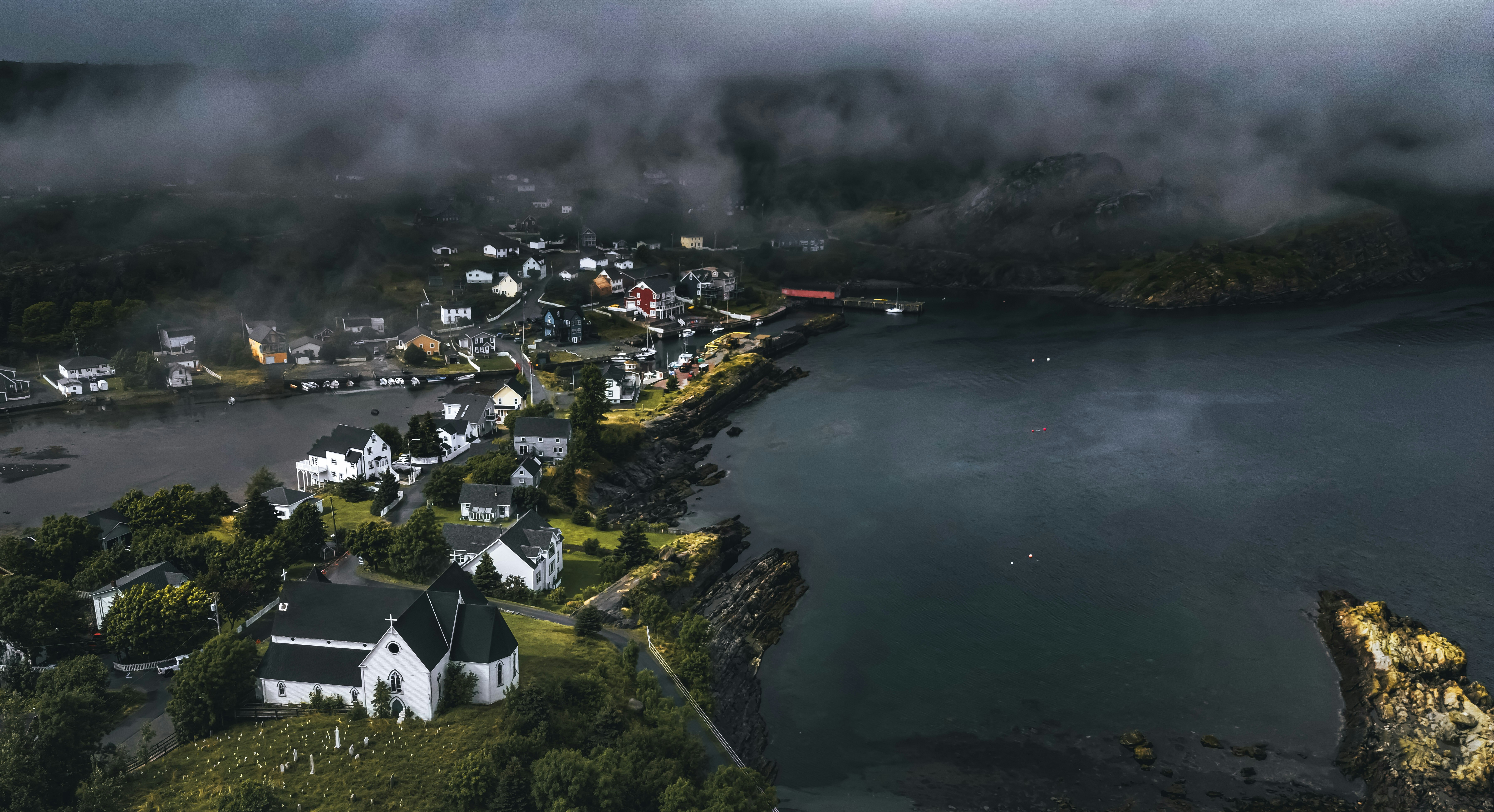 An aerial view of a small town by the water photo – Free Dark Image on ...