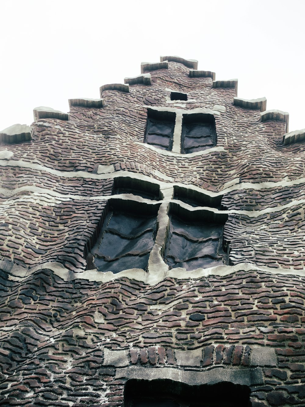 a very tall brick building with two windows