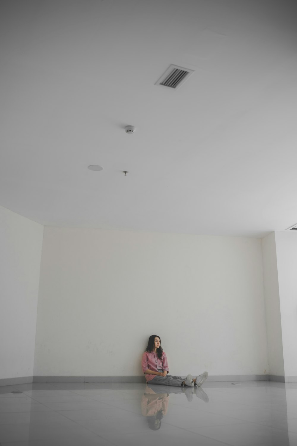 a woman sitting on the floor in a room