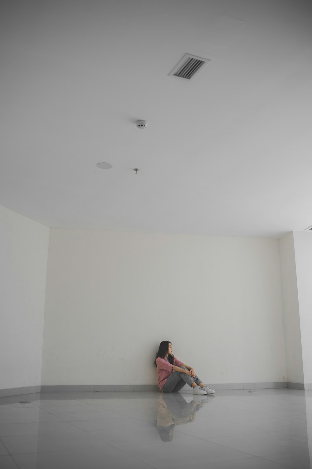 a woman sitting on the floor in a room