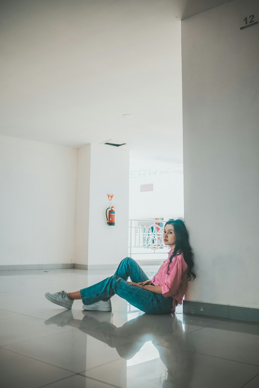 a woman sitting on the floor with her legs crossed