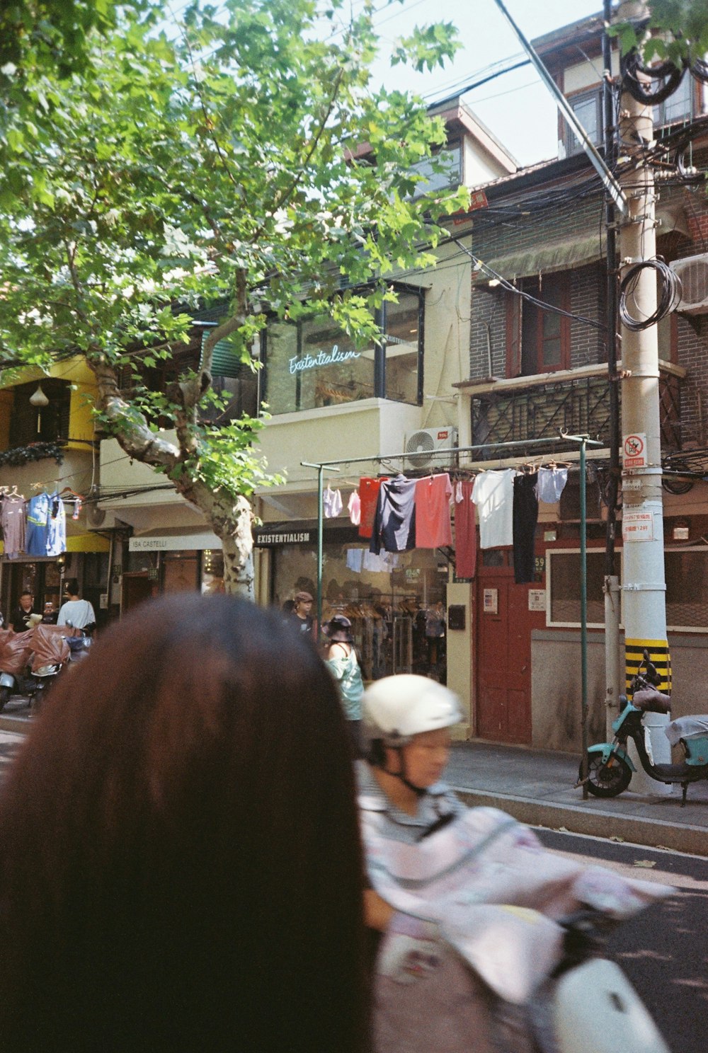 a group of people riding scooters down a street