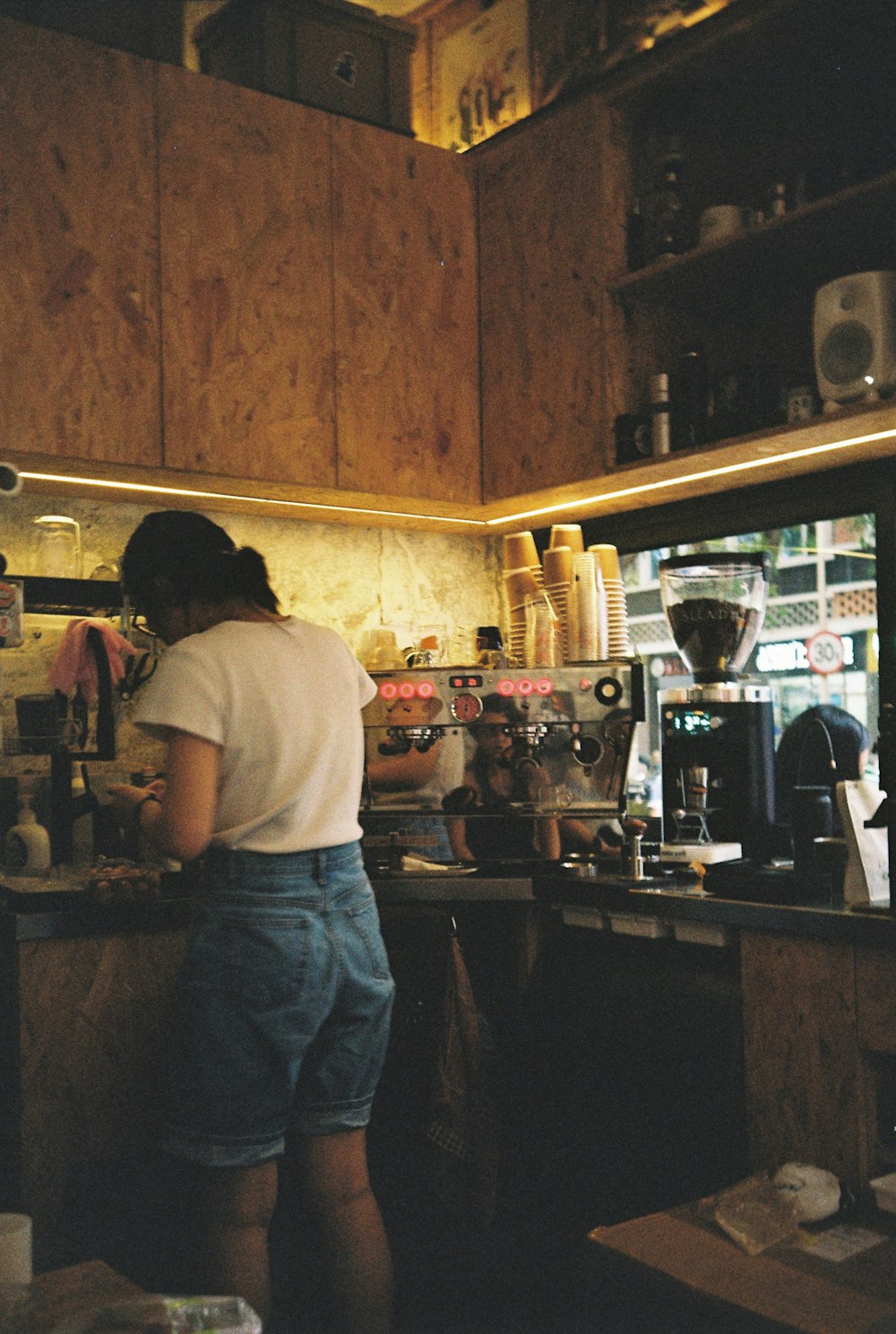 a woman standing in a kitchen preparing food