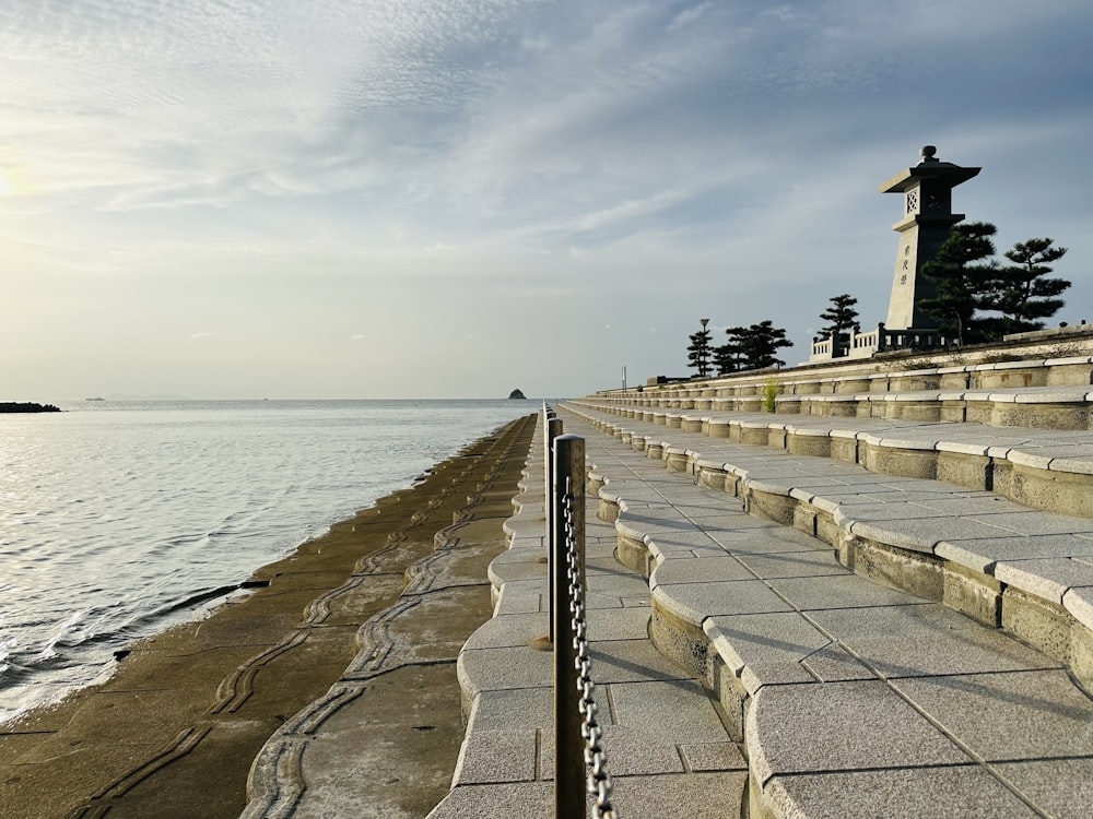 a row of stone steps next to a body of water