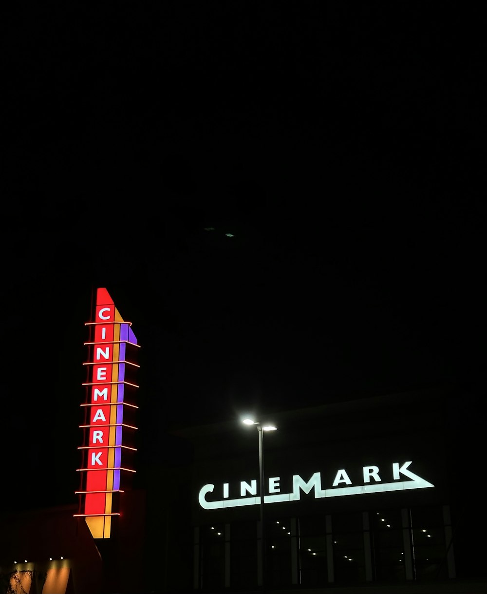 a large neon sign is lit up in the dark