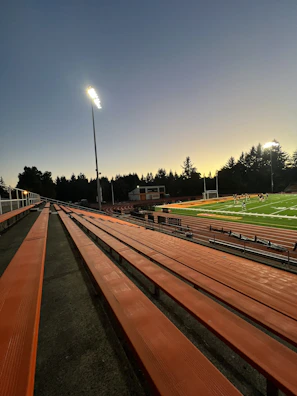 A dynamic shot of players sprinting toward the ball under bright stadium lights.