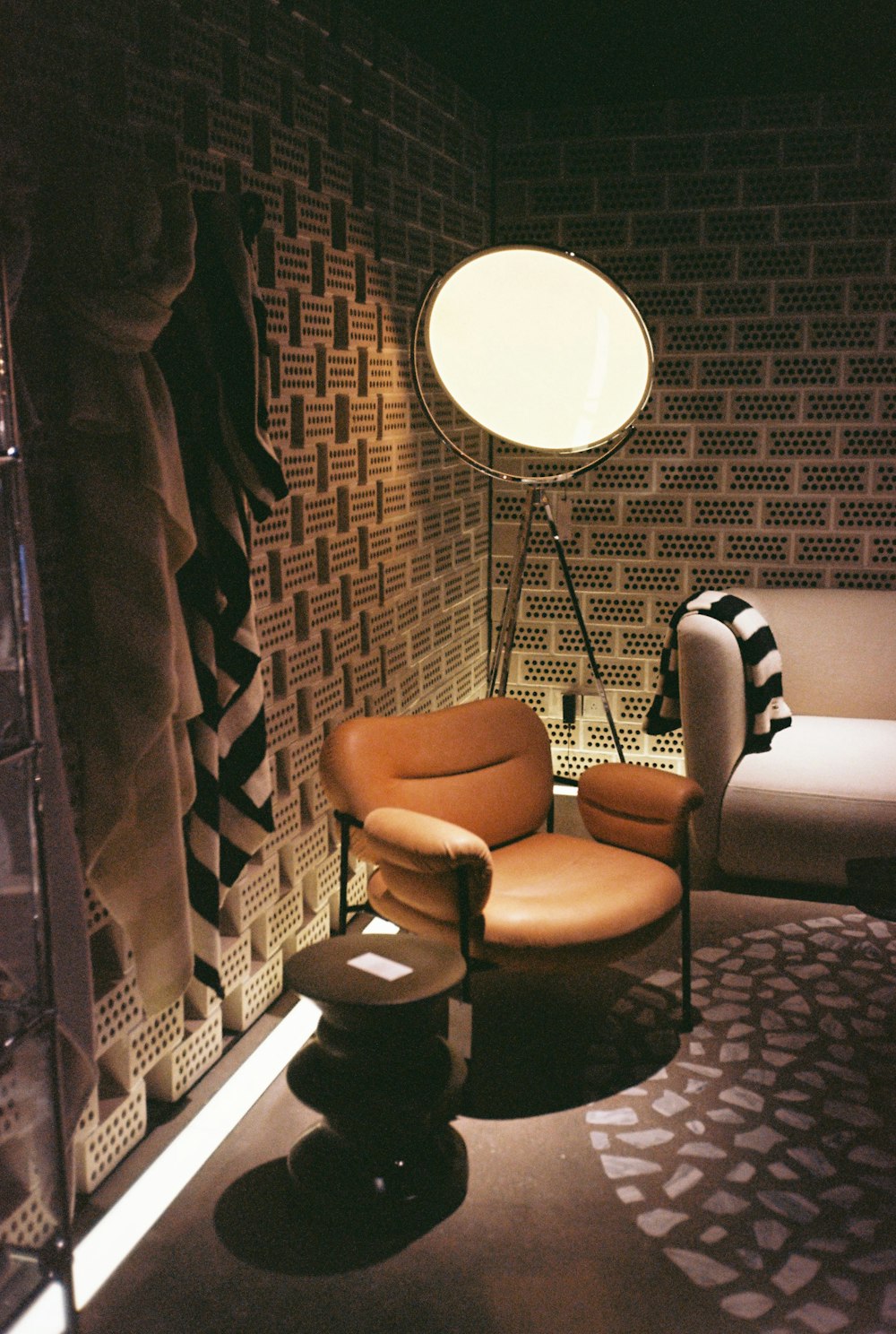 a living room with a chair and a lamp