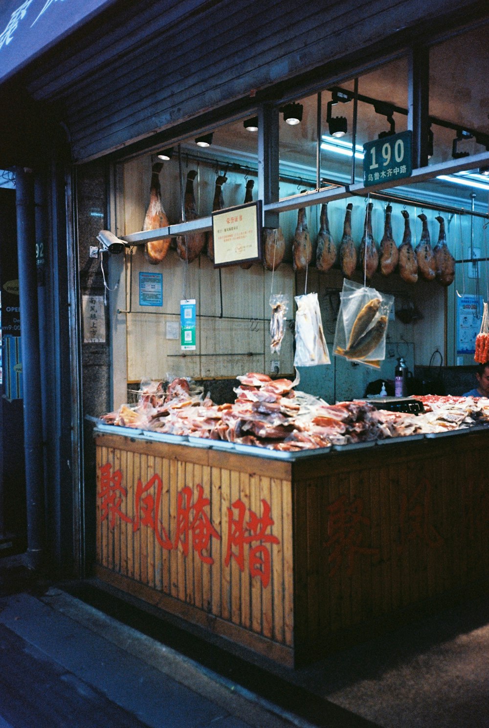 un stand de nourriture avec beaucoup de viande accrochée au mur