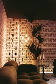 A luxurious living room showcasing a textured accent wall with subtle lighting highlights.
