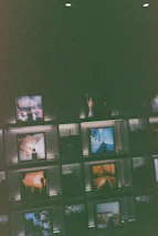 A moody shot of signed photo prints and posters arranged on a dark velvet surface.