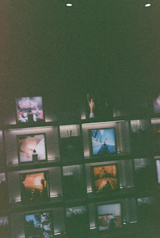 A moody shot of signed photo prints and posters arranged on a dark velvet surface.