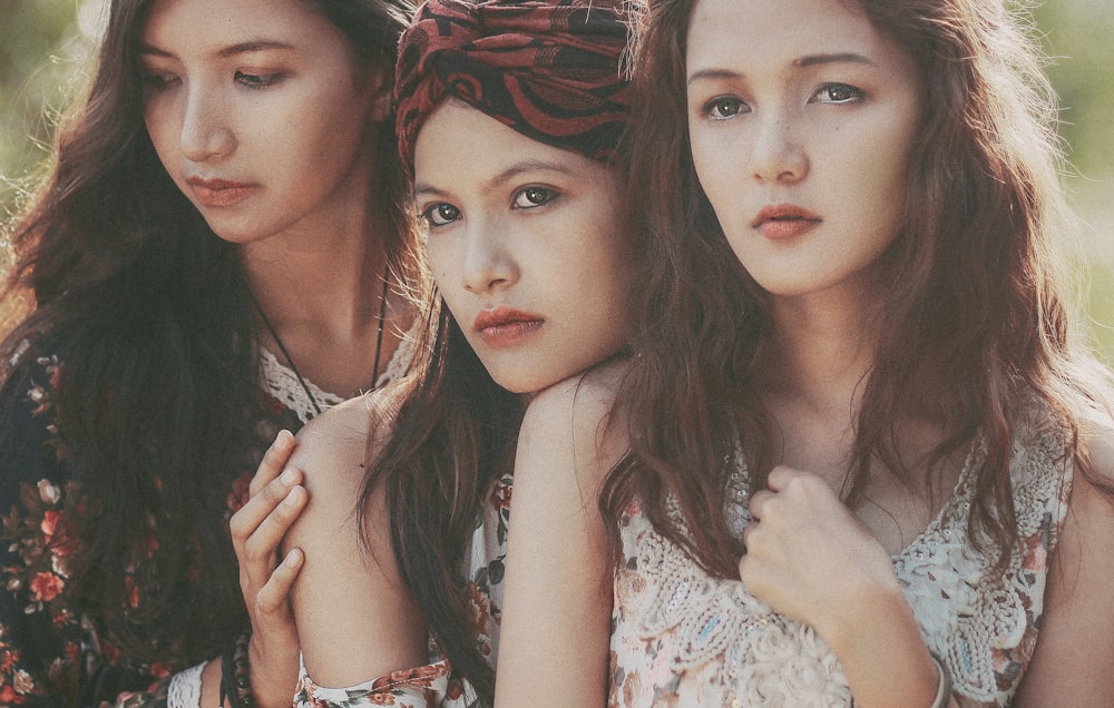 three young women standing next to each other