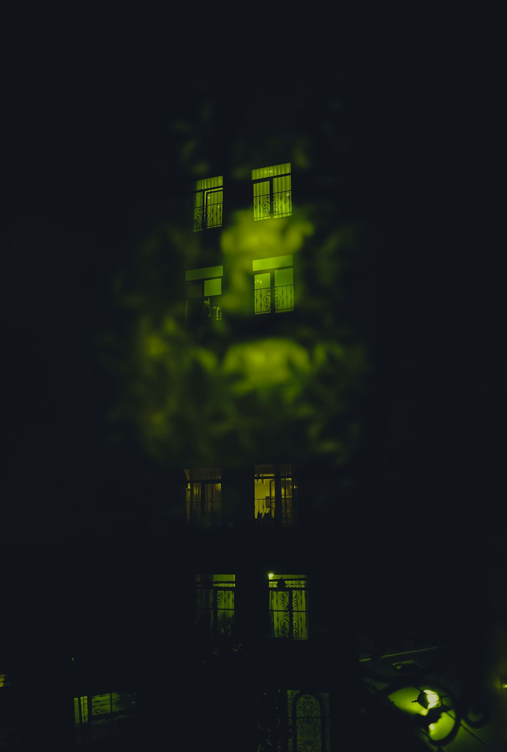 a building lit up at night with green lights