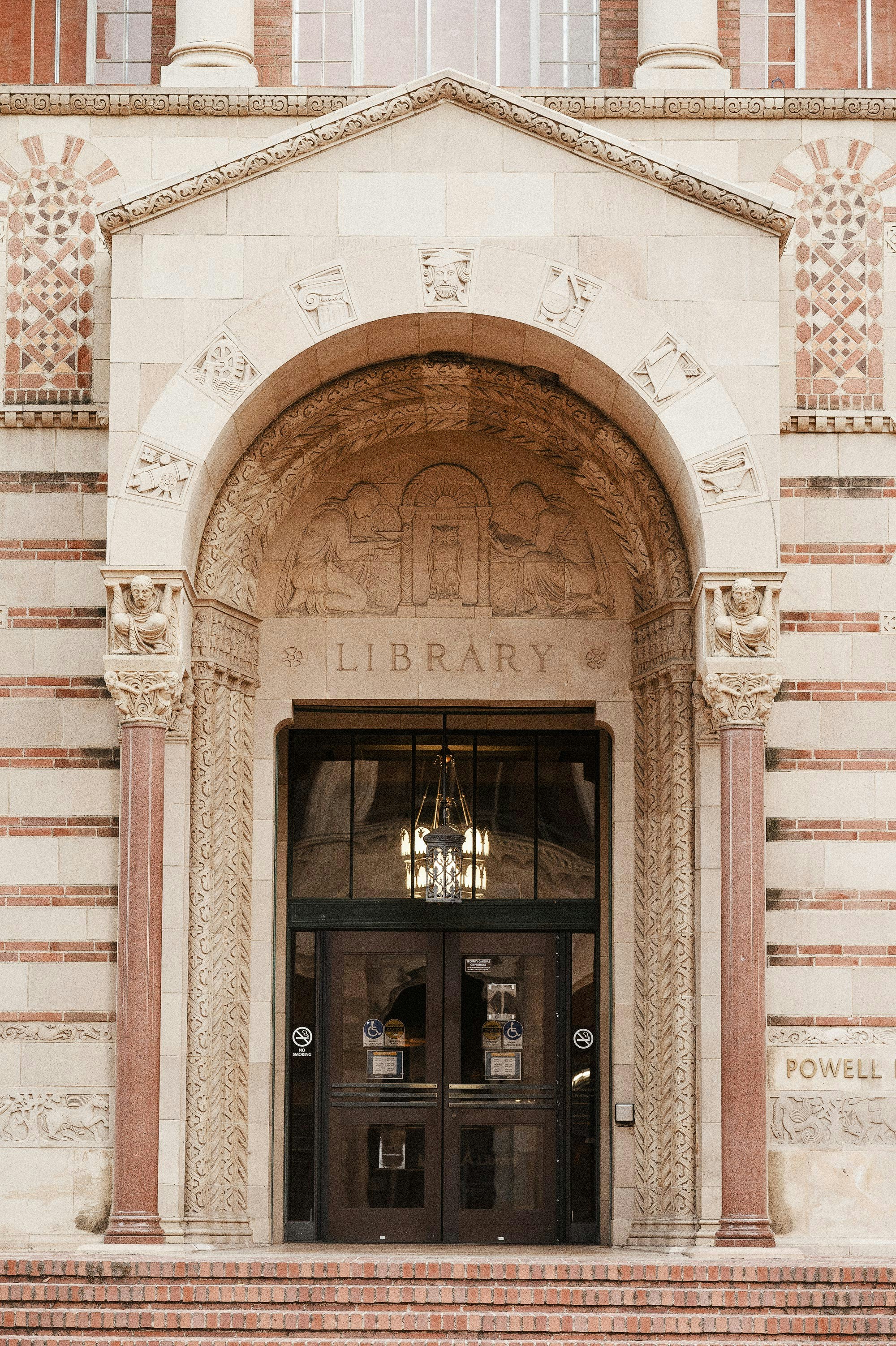 The front entrance of a library with a clock on the wall photo – Free ...