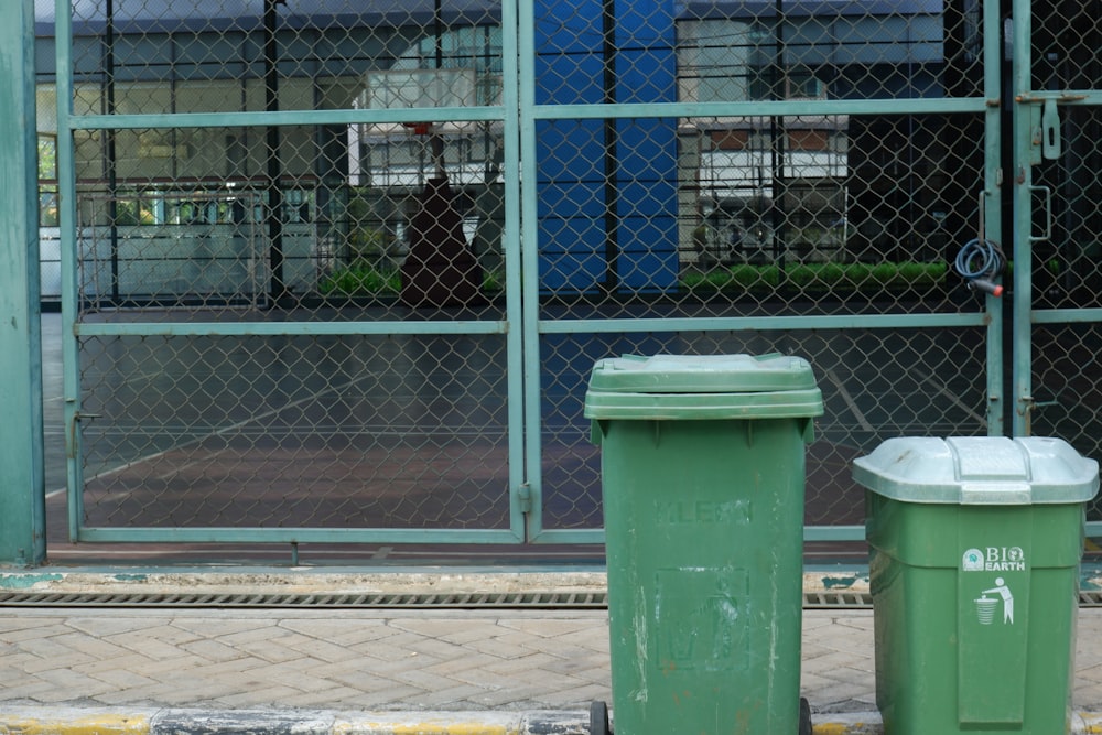 a couple of trash cans sitting next to each other