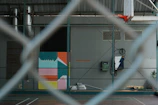 a basketball court is seen through a fence