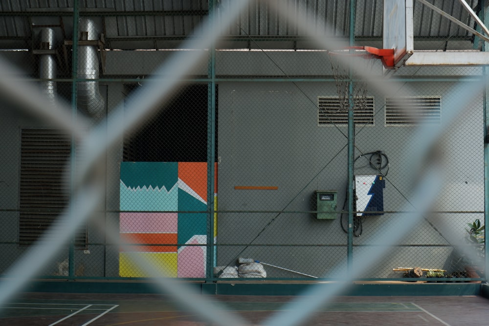 a basketball court is seen through a fence