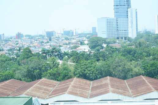 Green landscape with industrial buildings showing harmony between business and environment