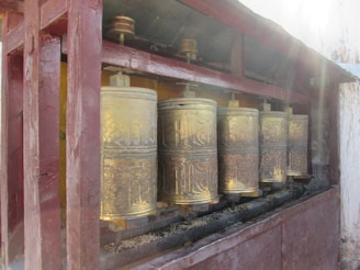 A close-up of a traditional Nepali prayer wheel spinning gently in the sunlight.