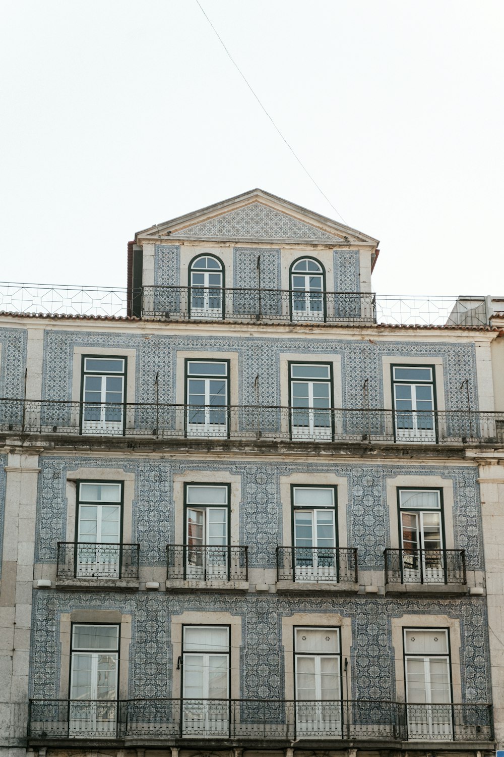 a tall building with many windows and balconies