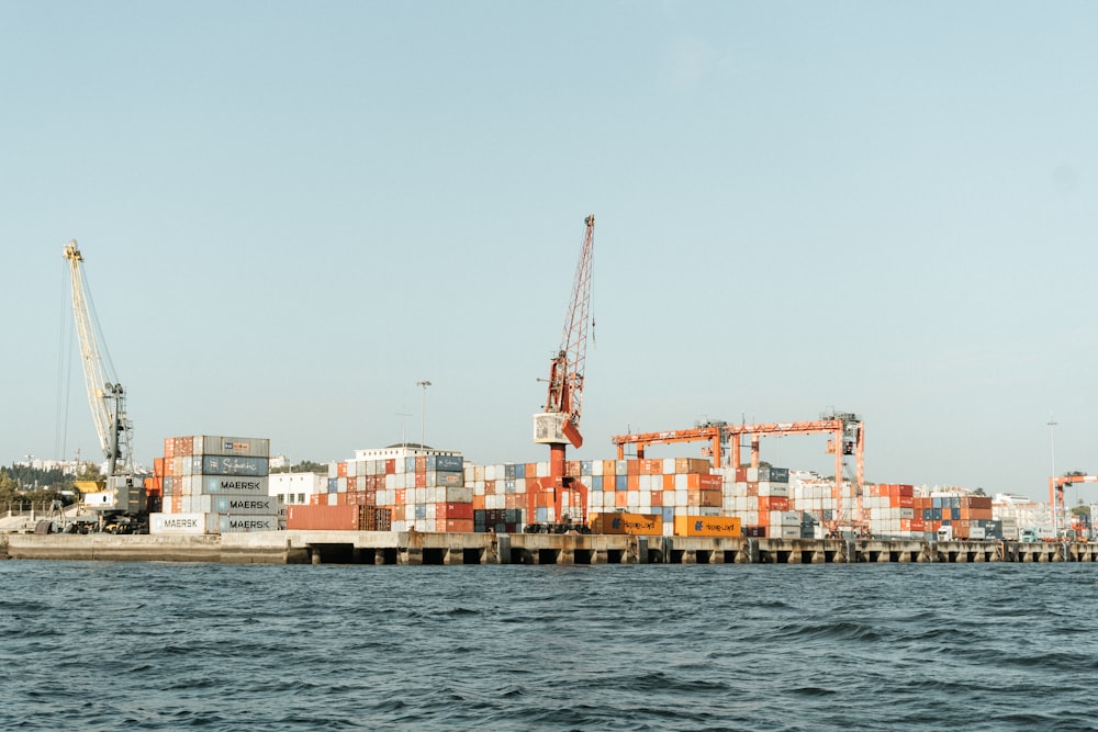 a large cargo ship in the water next to a dock