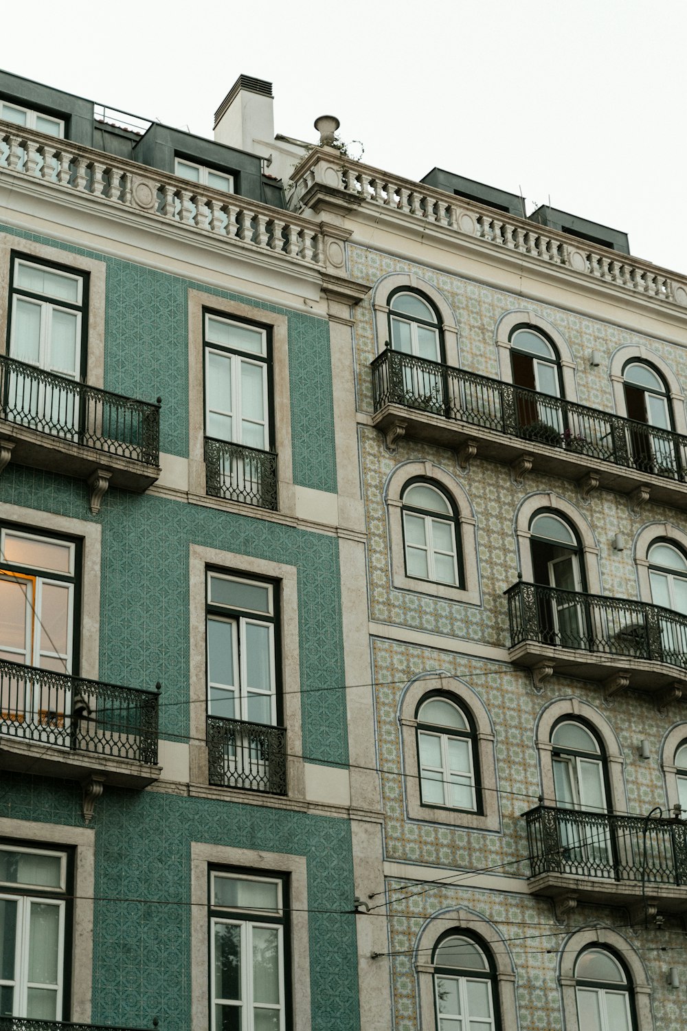 a tall building with many windows and balconies