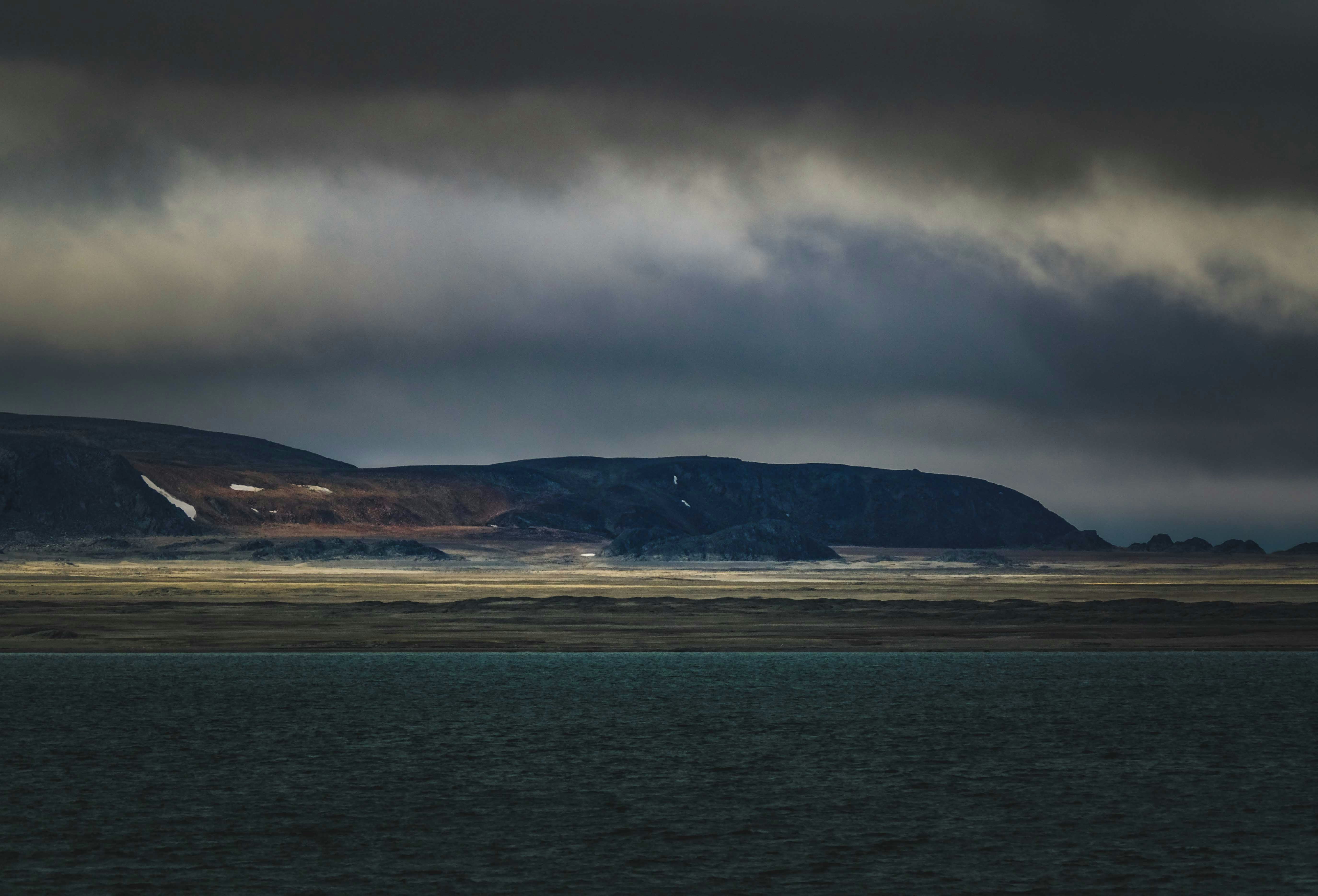 a large body of water under a cloudy sky